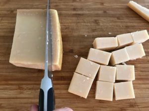 cutting the cheese into smaller blocks