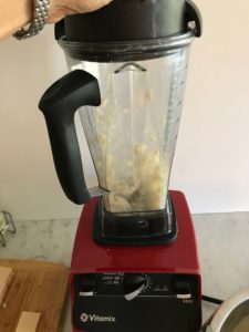 blender with cheese being chopped in it