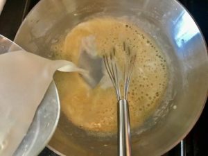 Milk poured in to butter and flour mixture in a pan