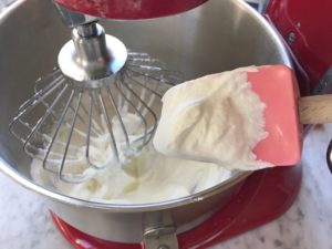 mixing bowl with heavy cream and spatula