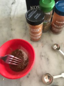 spices in a bowl mixed with a fork
