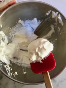 whipped cream on a red spatula