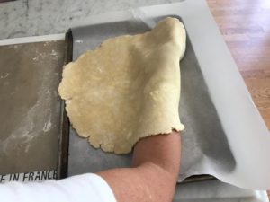 transferring the dough to a parchment lined baking sheet