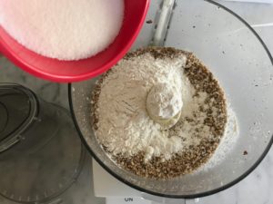 adding flour and sugar to the food processor