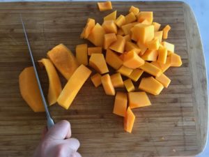 cutting the squash into cubes