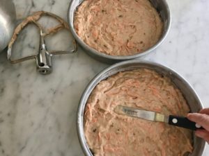 two round cake pans with cake batter in them