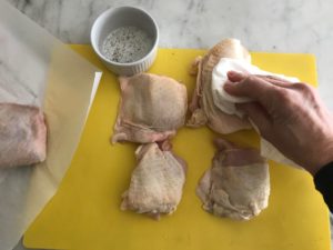 chicken on a place mat being dried with a paper towel