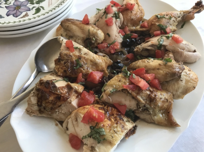 chicken with fennel, tomatoes, and olives on a serving platter