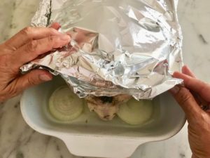 baking dish covered with foil on three sides