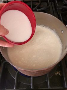 saucepan with milk, cream, and sugar being added