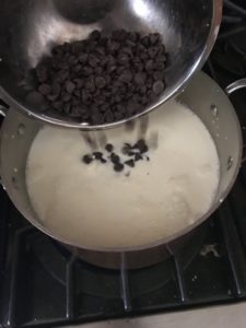 adding chocolate to the warm cream mixture