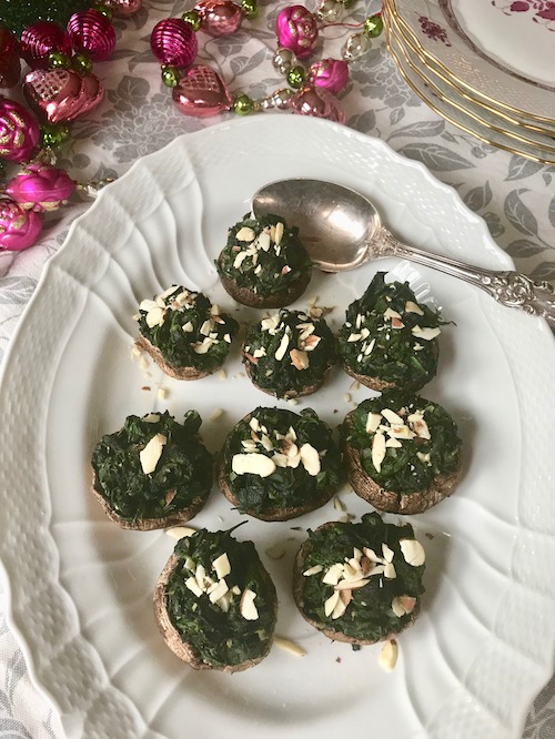 sauteed spinach stuffed mushrooms on a serving plate