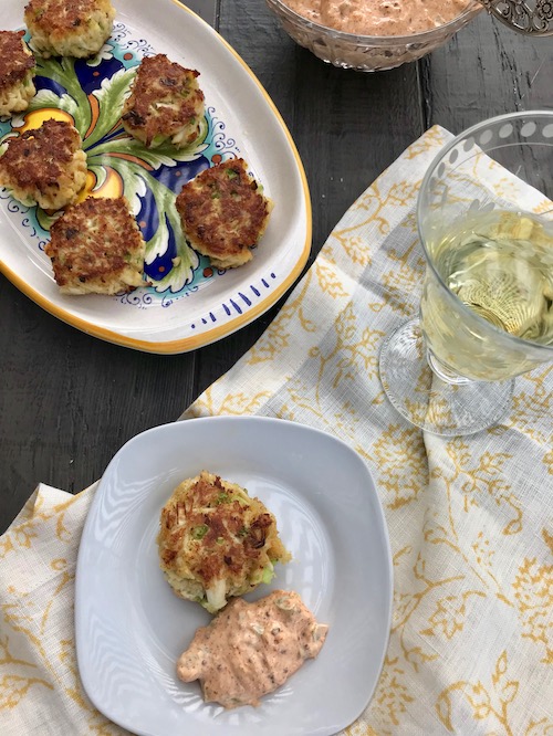 crab cakes and remoulade sauce on a serving platter