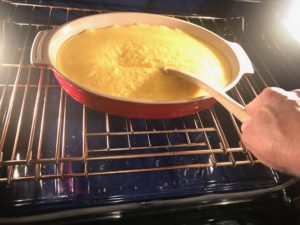 polenta in the oven being stirred
