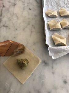 wonton wrapper with meat mixture in the middle