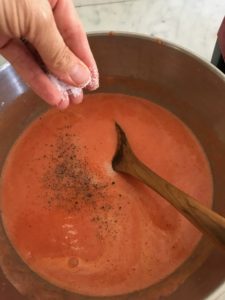 gazpacho with salt and pepper being added
