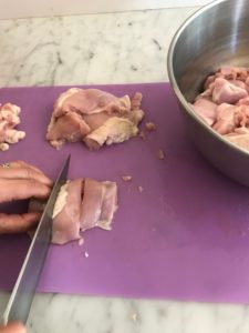 cutting the chicken into pieces