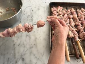 threading the chicken onto skewers