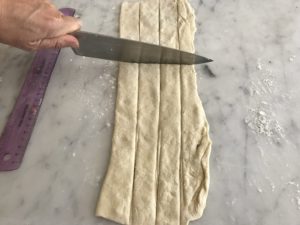 cutting the dough into strips