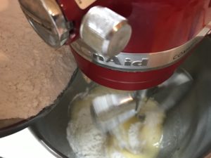 adding flour into the egg mixture