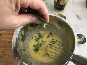 adding basil to the vinegarette
