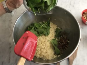 orzo and spinach being added to the pancetta mixture