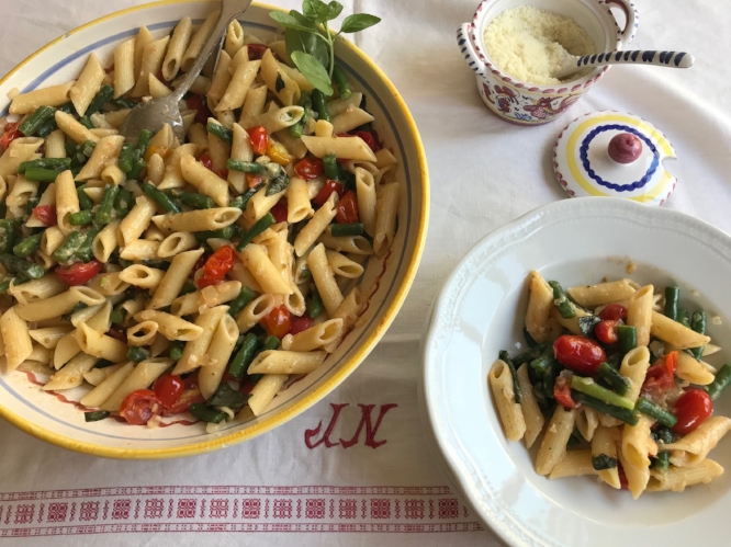 pasta with summer beans in a serving dish and pasta bowl