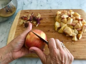 dicing the peaches on a cutting board