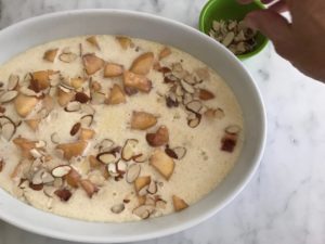 sprinkling almonds on top of the batter and fruit