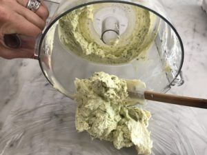 removing the butter from the food processor and putting it on plastic wrap