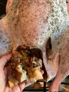 turkey with cavity being stuffed