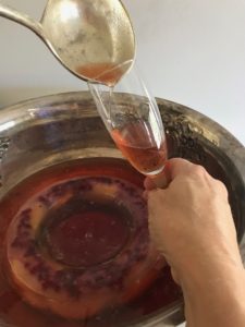 ladling punch into a champagne glass