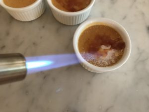 torching the sugar on the top of the creme brulee