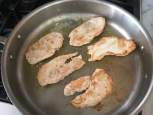 browned chicken in a saute pan