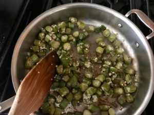 okra being sauteed in a saute pan