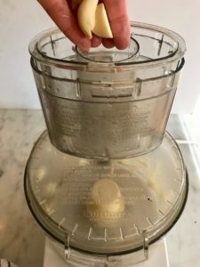Putting garlic in a food processor
