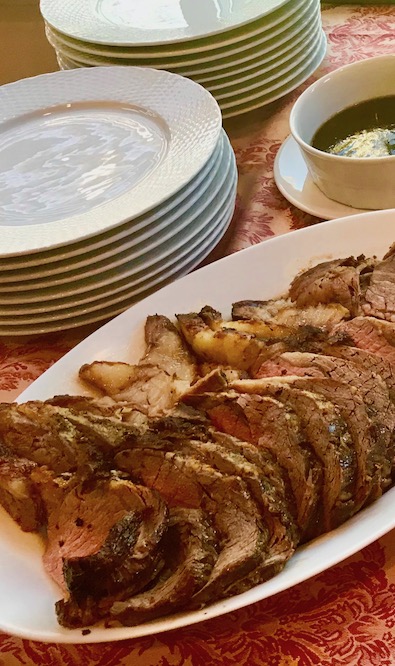 standing rib of roast beef on a serving platter