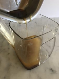 pouring pan drippings into a gravy separator