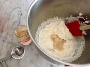 whipped cream with horseradish being folded into it