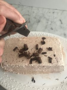 chocolate curls being sprinkled on finished semifreddo