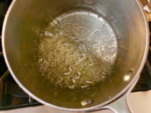 sugar and water mixture boiling in pot