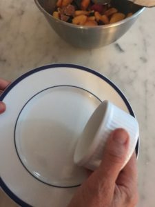 turning the ramekin upside down onto a serving plate
