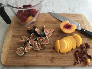 sliced figs and peaches on a cutting board
