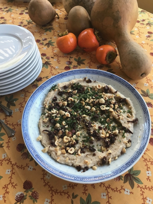 white bean and roasted garlic dip in a serving bowl