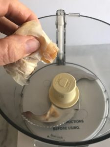 squeezing garlic into the food processor