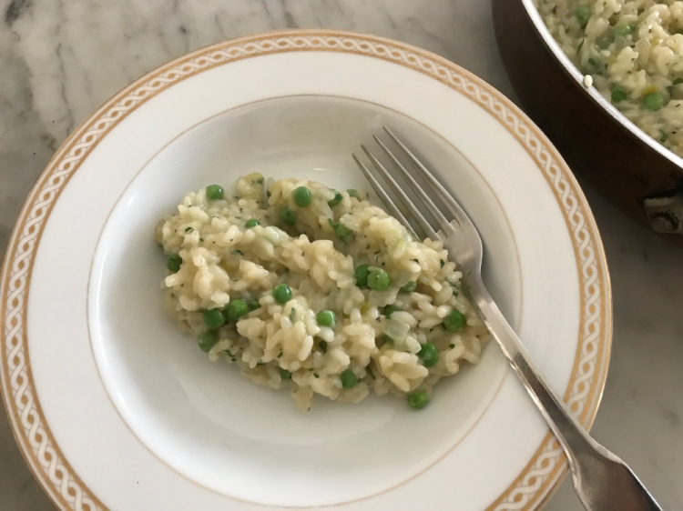 Risotto served in a white and gold plate