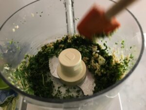 scraping down the sides of the food processor