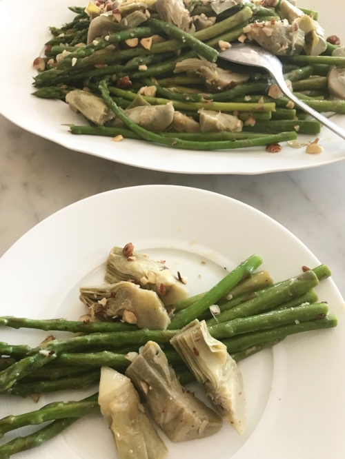 asparagus, artichokes, and hazelnuts on a serving plate