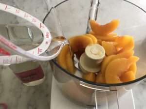 food processor with peaches in it