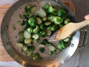 adding the brussels sprouts to the pan